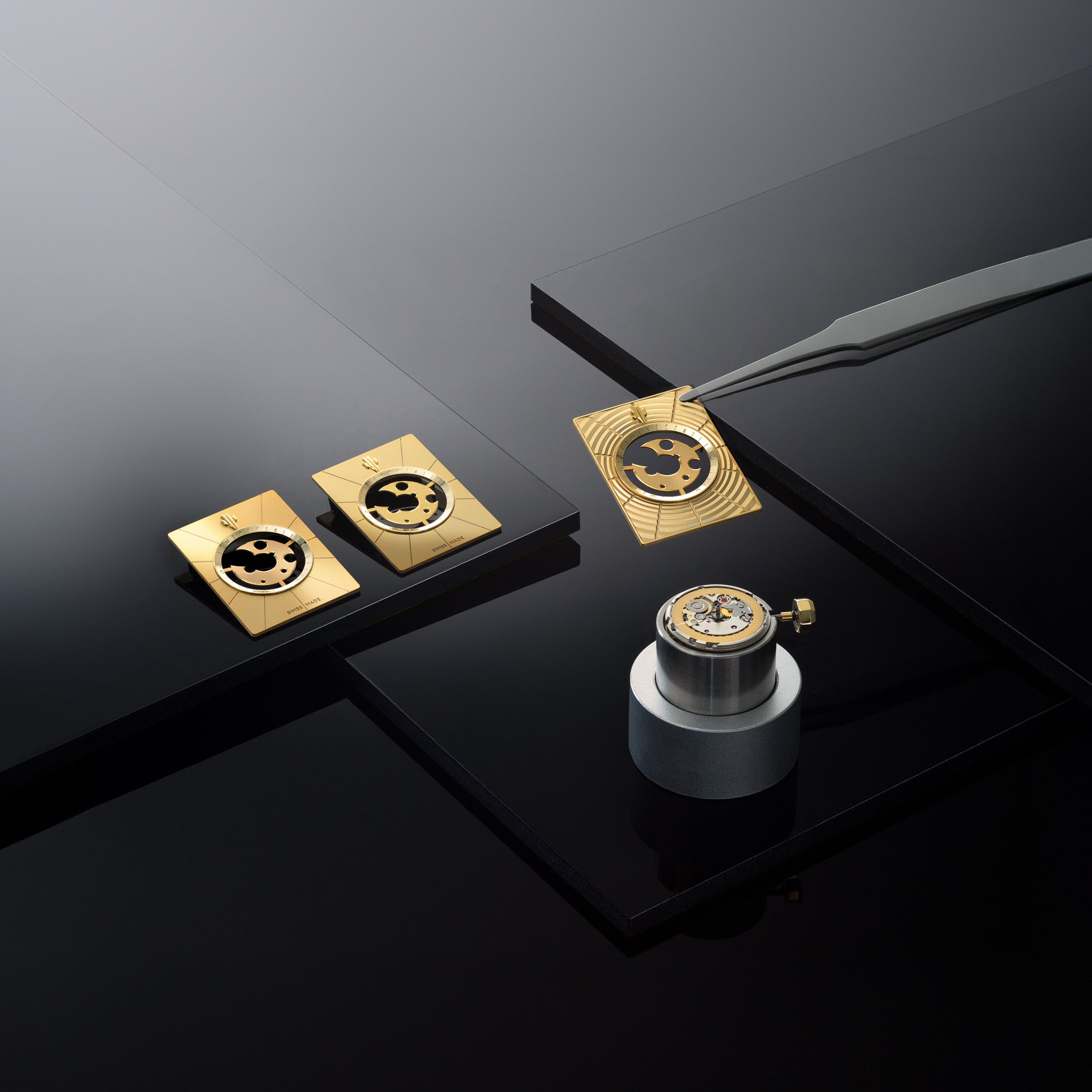  A meticulously arranged flat lay of gold Vieren watch dials, including finished and partially assembled components, displayed on a reflective black surface with precision tools and a mechanical movement holder. Photographed by Toronto-based commercial photographer Nicholas Hyatt, this luxury still life highlights fine watchmaking craftsmanship and contemporary design.